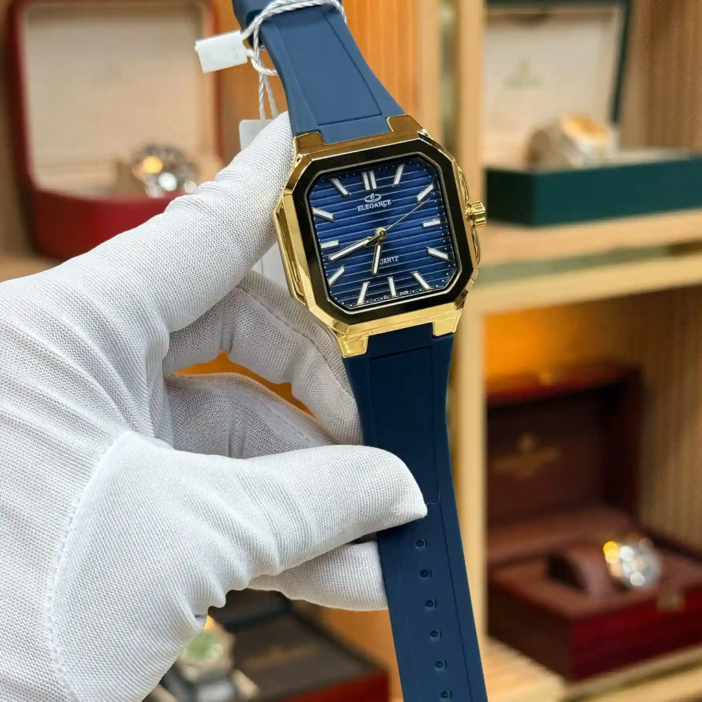 Blue dial wristwatch with gold-tone case and blue strap.