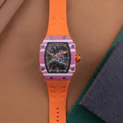 Luxury men's skeleton watch with black dial, pink striped case, and bright orange rubber band.