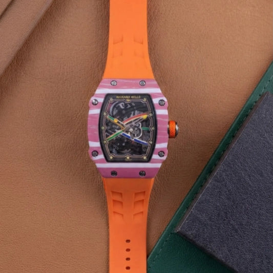 Luxury men's skeleton watch with black dial, pink striped case, and bright orange rubber band.