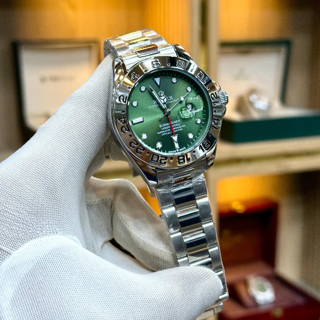 Rolex-style watch with a green dial and silver bracelet.