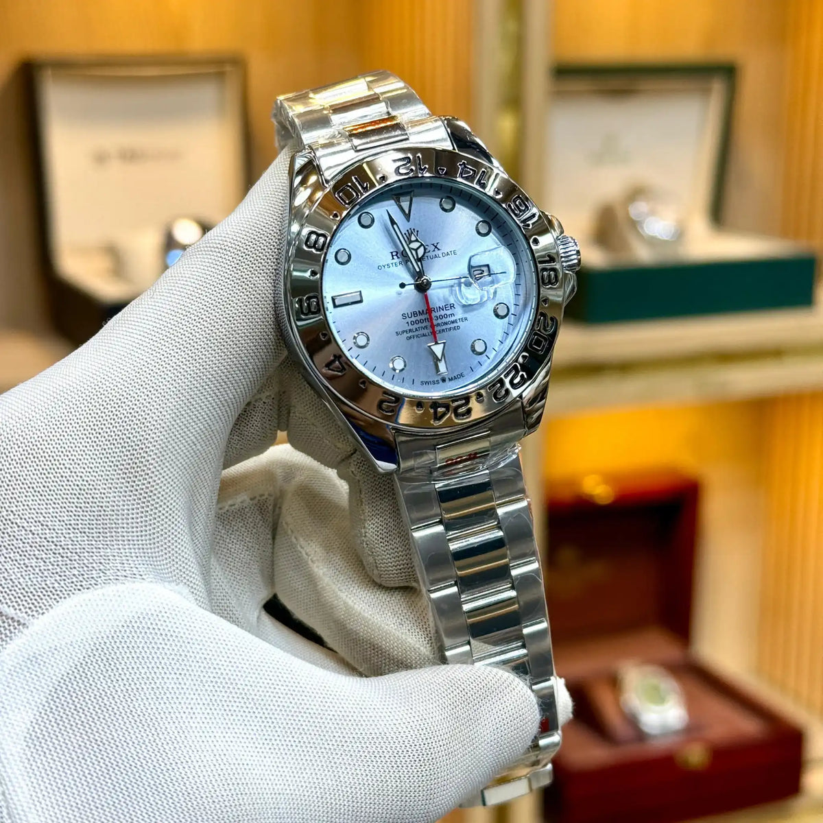 Rolex-style watch with a silver dial and silver bracelet.