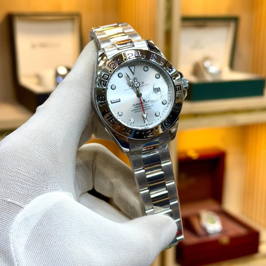 Rolex-style watch with a white dial and silver bracelet.