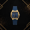Front view of Elegance luxury gold-tone watch featuring a textured deep blue dial and navy blue silicone strap.