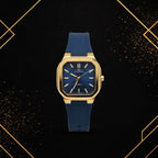 Front view of Elegance luxury gold-tone watch featuring a textured deep blue dial and navy blue silicone strap.