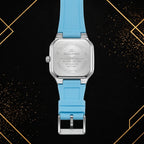 Rear view of the Elegance sky blue quartz watch showcasing the stainless steel case back, secure buckle, and silicone strap against an elegant black and gold background.