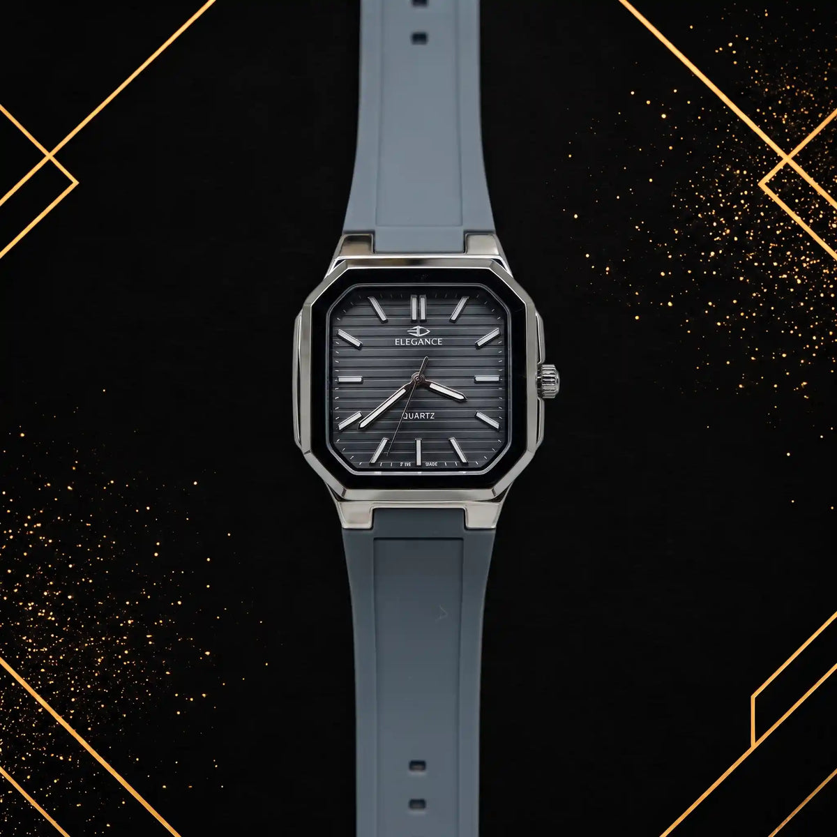 Elegance luxury men's quartz watch featuring a dark grey horizontal textured dial, polished silver octagonal case, and slate grey silicone strap, shown in a straight-on front view against a black and gold abstract background.
