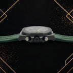 Side profile of the Extri men's black chronograph watch showcasing the crown, pushers, durable matte black stainless steel case, and green silicone strap.