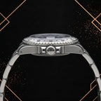 Horizontal side view of a steel wristwatch showing the knurled winding crown, case thickness, grooved bezel edge, and bracelet links.