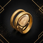 Top-down diagonal commercial photograph of gold snake wrap watch with champagne sunburst dial on luxury geometric background.