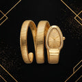 Front view of luxury women's serpent gold coiled bracelet watch with champagne oval dial, Roman numerals, and crystal bezel.