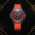 XTRI men's sports chronograph watch front view with black angular case, dark textured dial, and bright red silicone strap against luxury black and gold background.