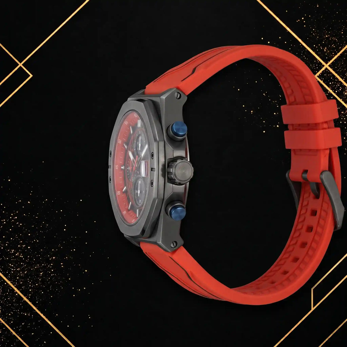 Right side profile of XTRI chronograph watch displaying matte dark gunmetal case thickness, crown, pushers, and red rubber strap on black and gold geometric backdrop.